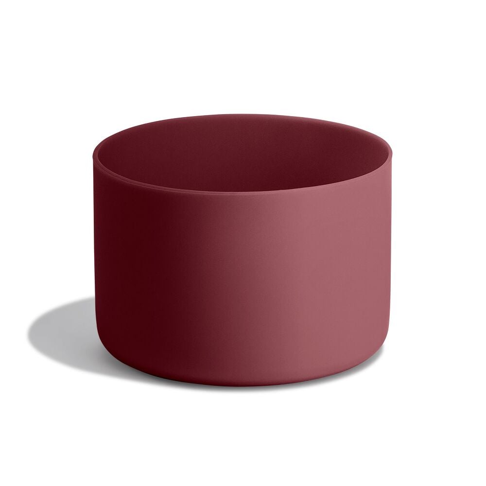Deep burgundy Hydro Flask cylindrical container with matte finish, smooth unadorned sides, and rounded rim. Minimalist design on a light gray surface.